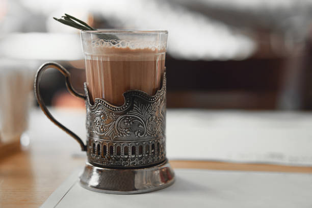 https://media.istockphoto.com/id/1087810726/photo/a-mug-of-hot-cocoa-with-a-rosemary-branch-in-a-vintage-metal-cup-holder-retro-style-food.jpg?s=612x612&w=0&k=20&c=ICP9auUxZA9g8s48k601egvt5EOQYA-dazi1aAvrINU=