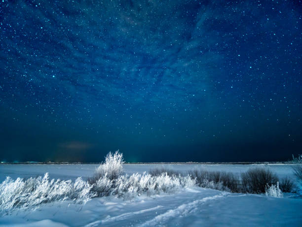 Snow at field and starry moonless winter sky Snow at field and starry winter sky. Snowy moonless winter night at northen of Europe. wintry landscape january december landscape stock pictures, royalty-free photos & images