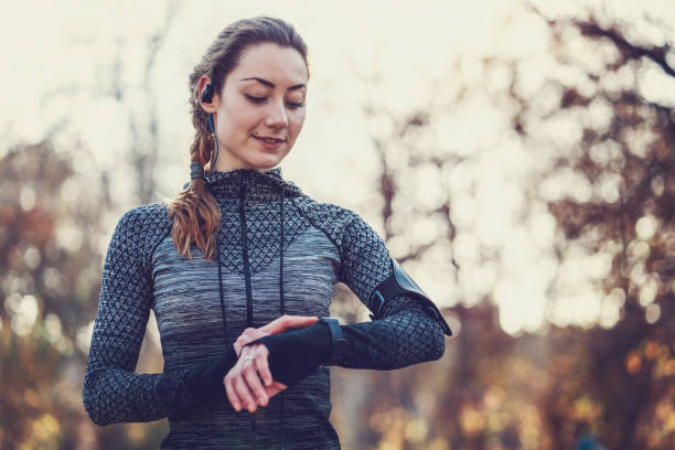 istock Young fit woman adjusting her smart watch 1087818198