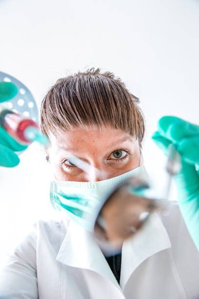 istock dental treatment with instrument 1087819602