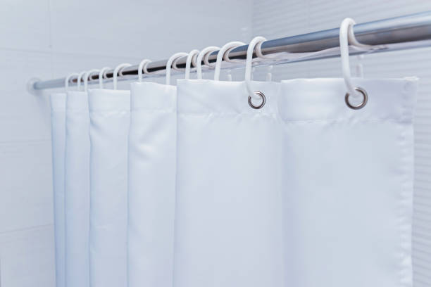 istock White bathroom with black and white shower curtain. 1087821416