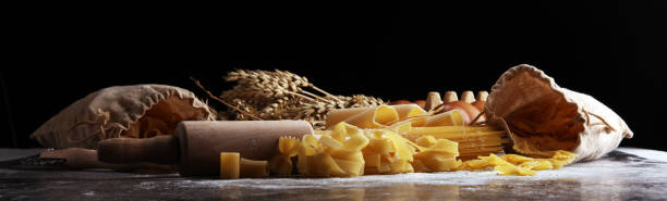 istock pasta. Fresh homemade pasta with pasta ingredients on the rustic table. 1087825714