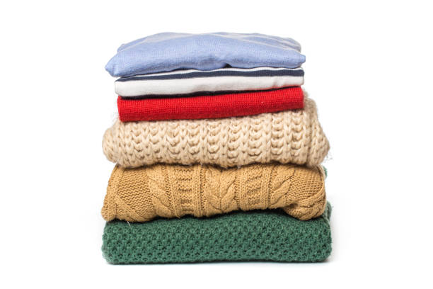 istock Stacks of folded clothes on white background 1087825942