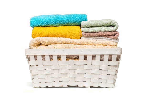 istock Clothes in a laundry wooden basket isolated on white background 1087825948