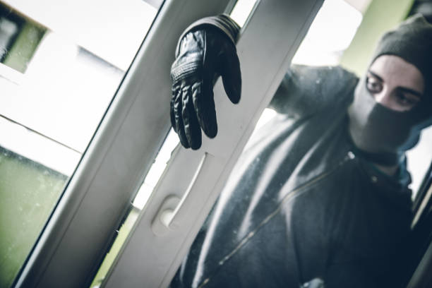 istock Burglar Breaking Into House 1087826102