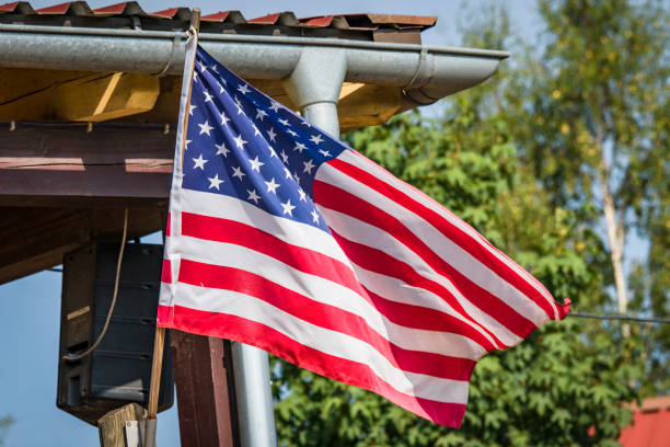 istock American flag on a porch outside a small cabin 1087833892