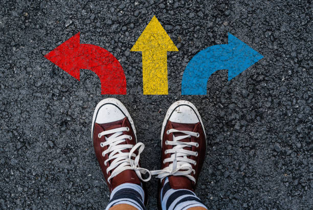 istock colorful direction arrow choices on asphalt 1087835326