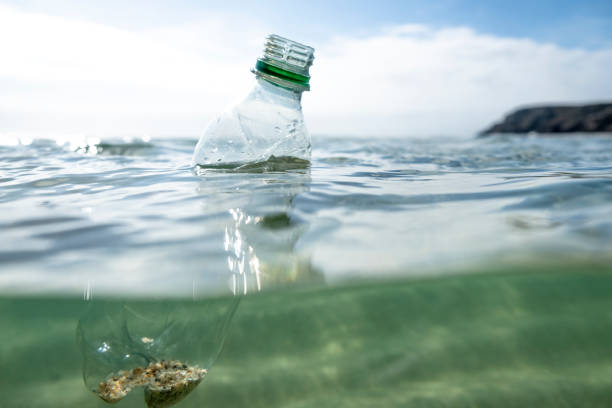 istock Used Plastic Water Bottle floating on the sea surface. 1087837566