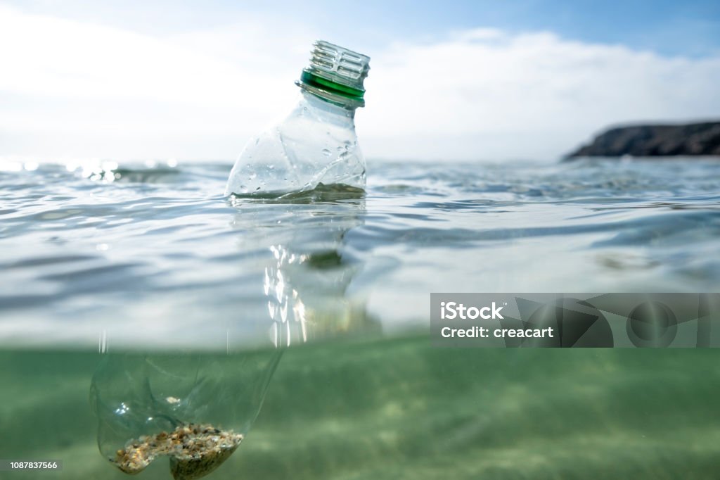 Used Plastic Water Bottle floating on the sea surface. Sea Stock Photo
