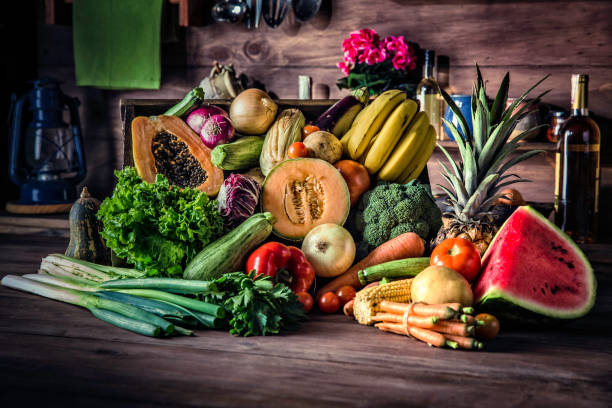 istock Organic tropical fruits and vegetables in old fashioned rustic kitchen 1087839588
