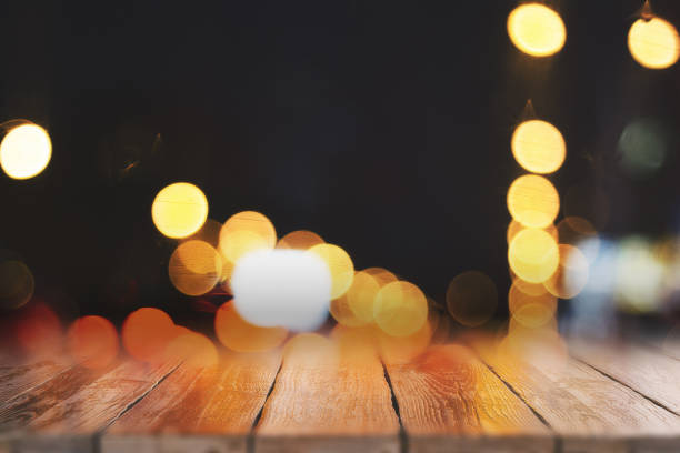 istock Blurry wooden desktop with bokeh lights 1087839808