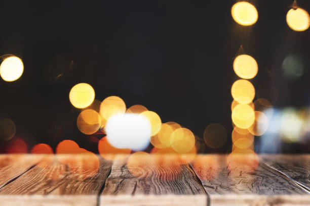 istock Blurry wooden table with bokeh lights 1087839880