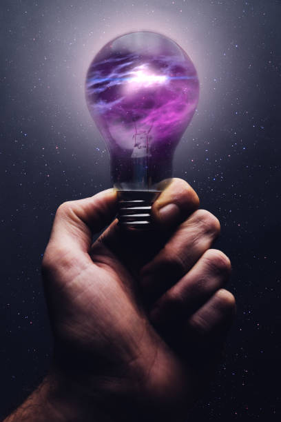 istock Human hand holding light bulb with nebula dust inside and sunshine. Mixed media. 1087841568