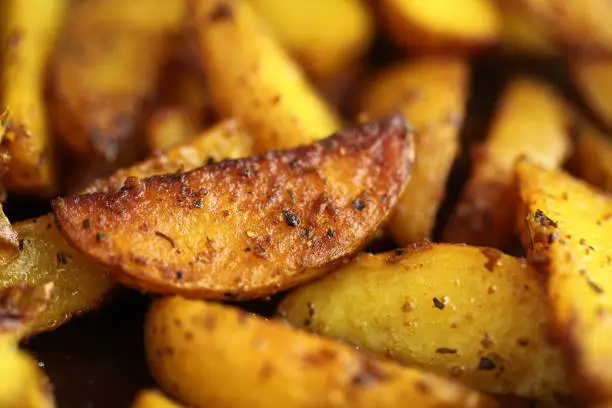 Photo of fried in ghee with spices pieces of potatoes