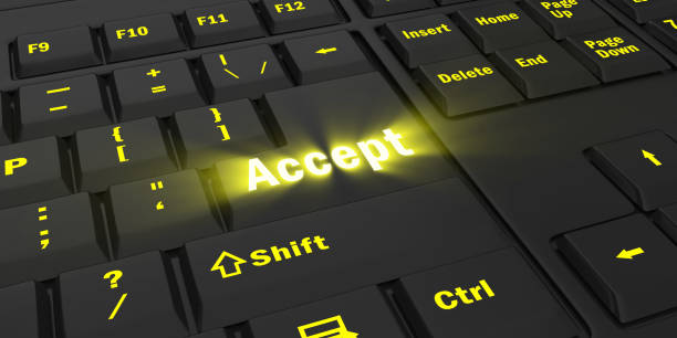 istock yellow glowing Accept key on black keyboard 1087847228