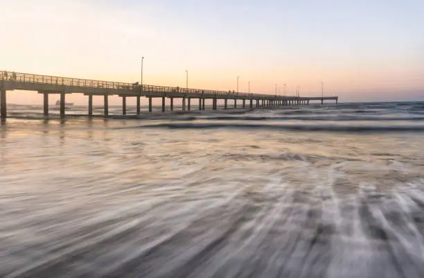 long exposure of the waves coming in near the Horace Caldwell Pier in Port Aransas Texas