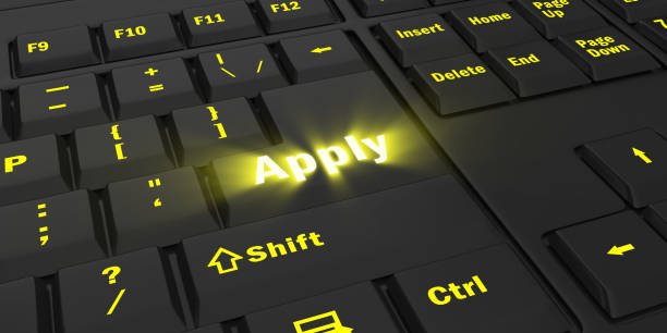 istock yellow glowing Apply key on black keyboard 1087847398
