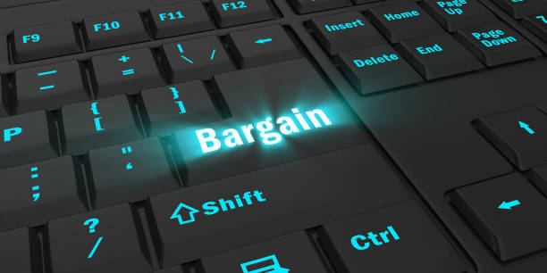 istock blue glowing Bargain key on black keyboard 1087847592