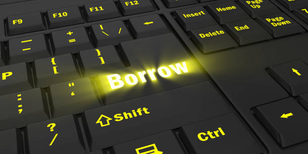 istock yellow glowing Borrow key on black keyboard 1087847710
