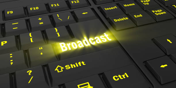 istock yellow glowing Broadcast key on black keyboard 1087847814