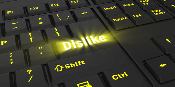 istock yellow glowing Dislike key on black keyboard 1087849432