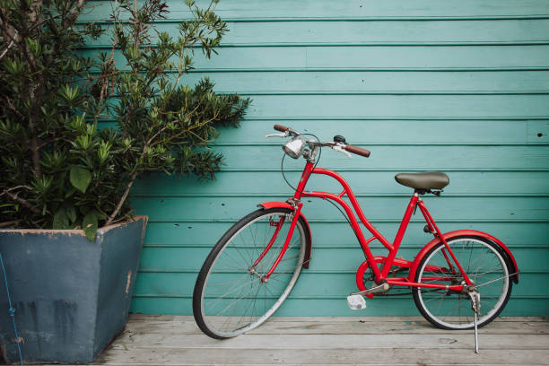 istock Old bicycle on wooden background 1087849868