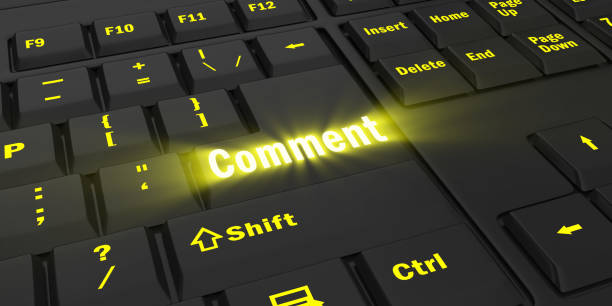 istock yellow glowing Comment key on black keyboard 1087850038