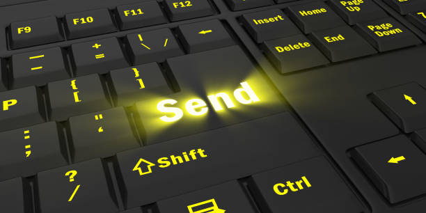 istock yellow glowing Send key on black keyboard 1087854474