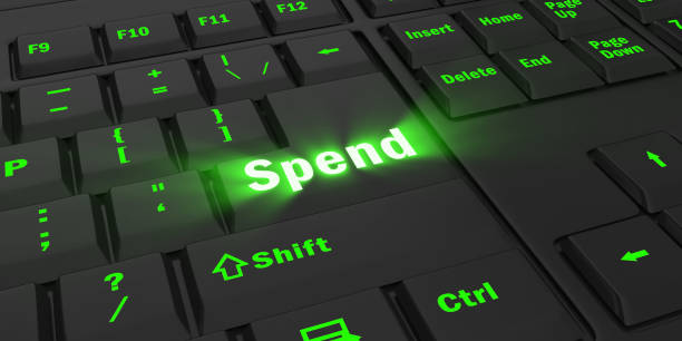 istock green glowing Spend key on black keyboard 1087854558