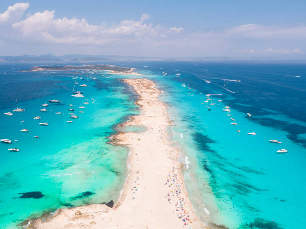 Formentera aerial view of turquoise water and yachts anchored Aerial overhead view of large amount of yachts anchored off the coast of Formentera Ibiza, with turquoise Mediterranean Sea and ocean blue water. ibiza town stock pictures, royalty-free photos & images