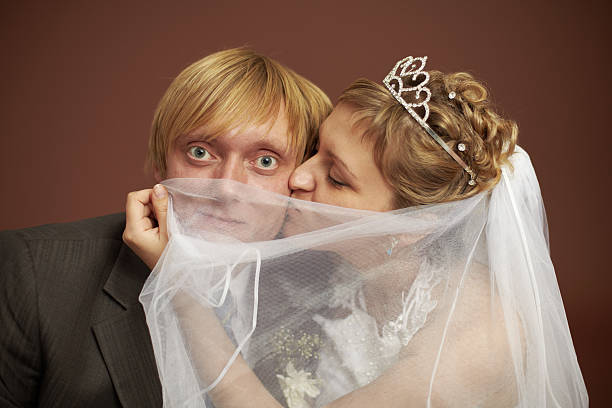 Funny bride and groom Funny bride and groom were closed veil bride hiding face stock pictures, royalty-free photos & images
