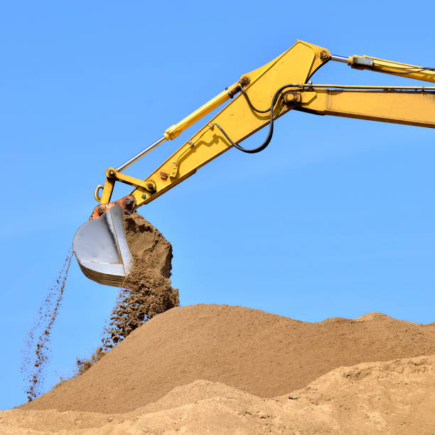 istock new yellow excavator working on sand dunes. Scoop close-up 1087862968