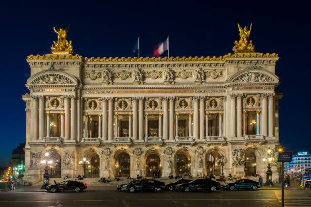 People walking at night in the Place de l´opera (Opera square) next to the Palais Garnier Opera House (Opera du Paris) at Paris city, France. People walking at night in the Place de l´opera (Opera square) next to the Palais Garnier Opera House (Opera du Paris) at Paris city, France. Inaugurated in 1875, it is one of the most famous places in Paris. place de lopera stock pictures, royalty-free photos & images