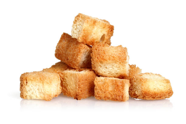 Tiny bread cubes isolated on white background Tiny bread cubes isolated on white background. Macro, studio shot mini wheat cereal stock pictures, royalty-free photos & images