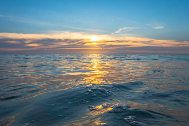 istock bubble of wave in te sea at sunset 1087874316