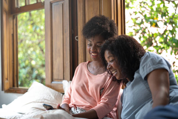 istock Mother and Daughter Using Mobile Phone in the Bed 1087876066