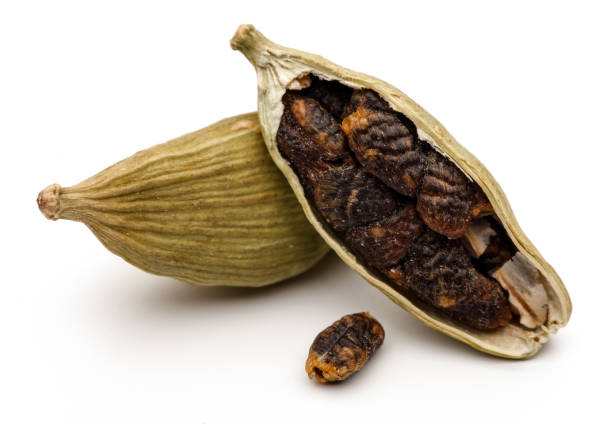 istock Green cardamom pods and seeds on white background 1087876518