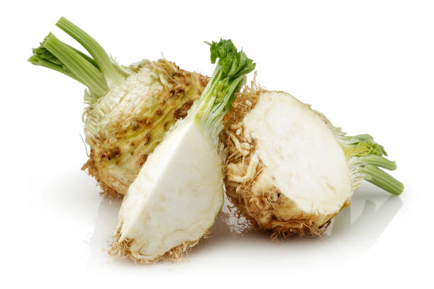 Fresh celery stalks and celeriac on white background Fresh celery stalks and celeriac isolated on white background. Studio shot. Celeriac stock pictures, royalty-free photos & images