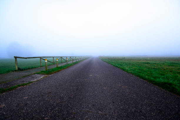 istock Secondary Road with fog 1087885870