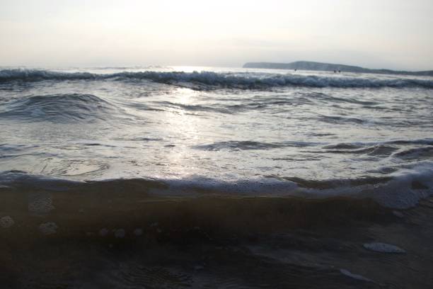 istock Gentle waves washing a beach in the evening 1087886298