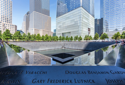 North pool at the National September 11 Memorial & Museum in New York City on September 2017 with World Trade Center One in the background.