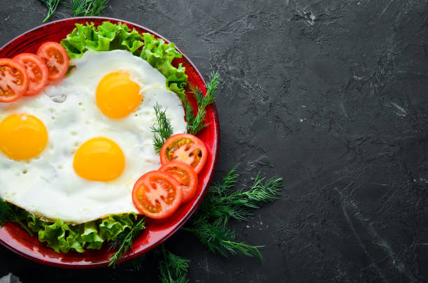 istock Eggs with tomatoes and fresh vegetables. Breakfast. Top view. Free space for your text. 1087906152