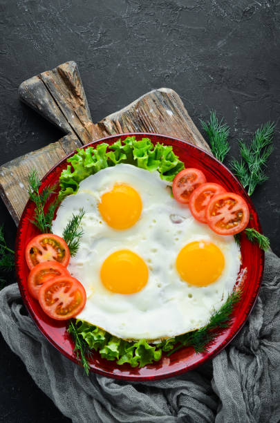 istock Eggs with tomatoes and fresh vegetables. Breakfast. Top view. Free space for your text. 1087911760