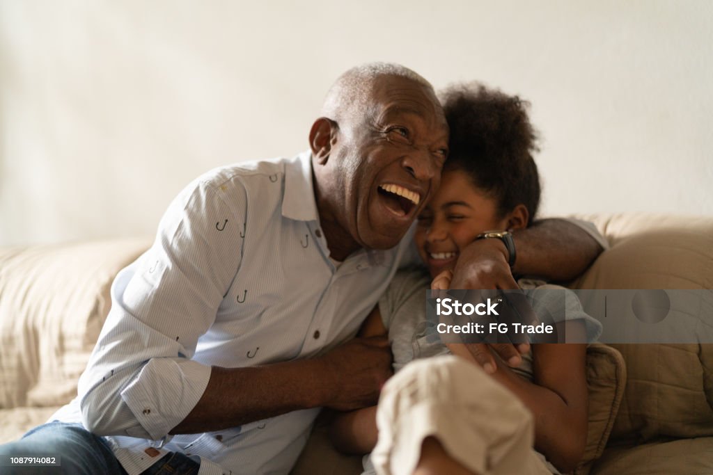 Grandfather Playing with Her Granddaughter at Home My love Granddaughter Family Stock Photo