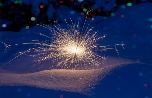 istock Festive background. Bengal fire, fireworks, spark, snow, bokeh effect. Christmas or New Year. Selective focus, close-up. 1087919498