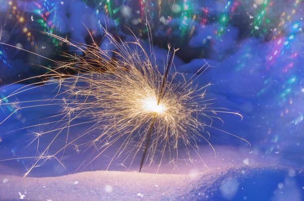 istock Festive background. Bengal fire, fireworks, spark, snow, bokeh effect. Christmas or New Year. Selective focus, close-up. 1087919634