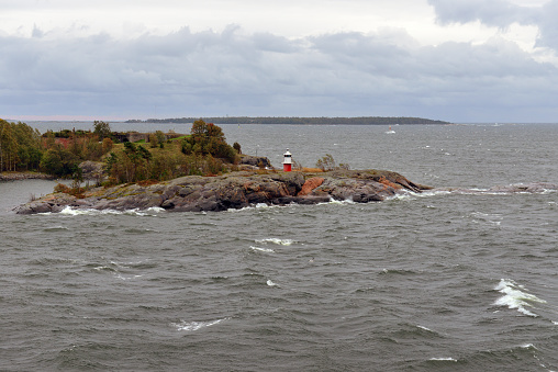 Lighthouse in Autumn Baltic Sea. Gloomy windy day