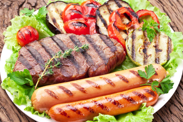 istock Grilled meat and vegetables over green leaves. 1087927358