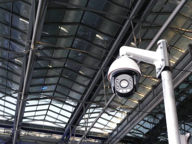 istock CCTV security camera on tall metal post  against high ceiling transparent roof 1087927598