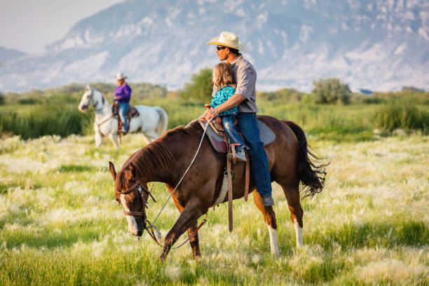 istock Cowboy riding with his little daughter 1087932598
